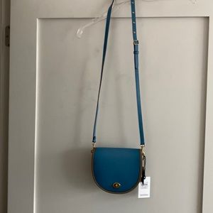 Authentic Coach handbag. Crossbody Turnlock Saddlebag. Leather. Beautiful!